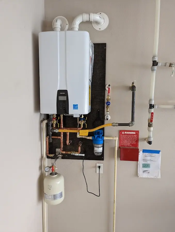 Professional plumber installing copper piping in a Lake Wissota home